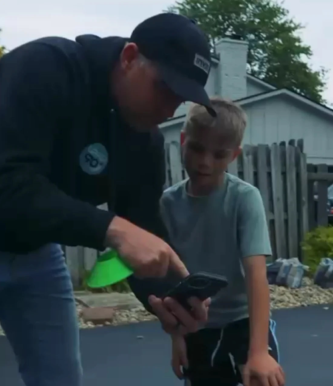 Coach guiding a young player with the SogilityGO app